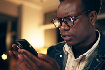 Bad news, face and phone with business black man closeup...