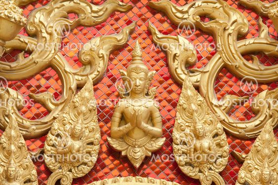 the gold stucco design of native thai style on the Wall