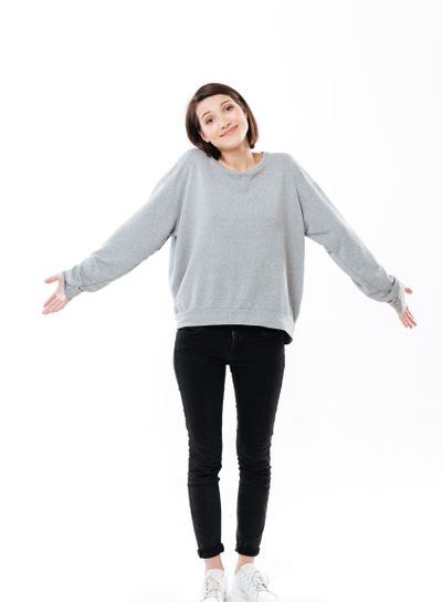 Full length portrait of a young cinfused girl shrugging...