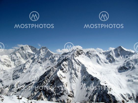 Mountain under the blue sky and the clouds