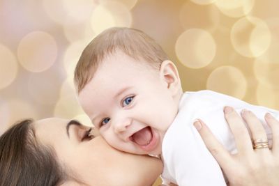laughing baby playing with mother