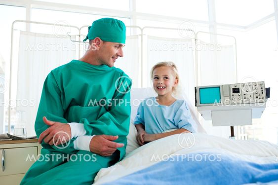 Attractive surgeon explaining a surgery to a child patient