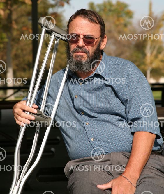 Older gentleman holding crutches