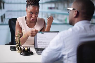 Female Lawyer And Her Client Discussing Divorce Proceedings