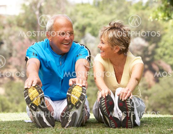 Senior Couple Exercising In Park