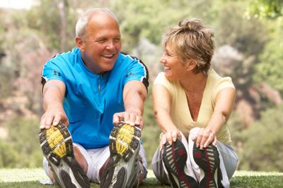 Senior Couple Exercising In Park