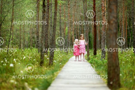 Two cute little sisters outdoors