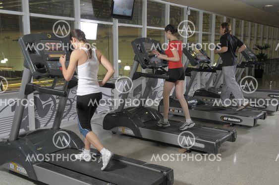 Group of people running on a treadmill at gym