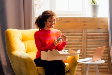 A young attractive African woman in casual clothing is...