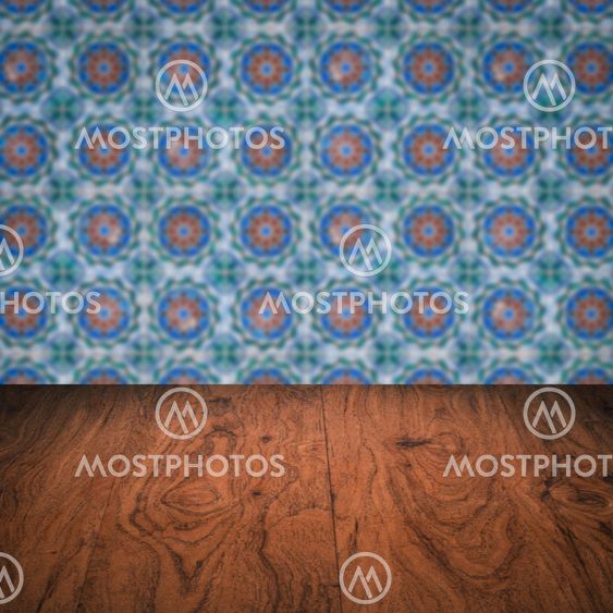 Wood table top and blur vintage ceramic tile pattern wall