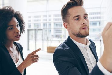 Business people, writing and discussion with whiteboard...