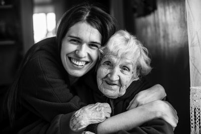 Young woman embracing his elderly mother. Black and white...