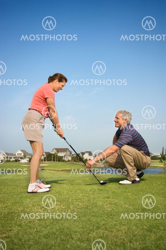 Couple playing golf.
