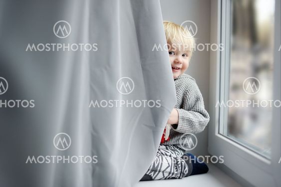 Toddler boy on the window sill