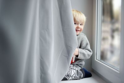 Toddler boy on the window sill 