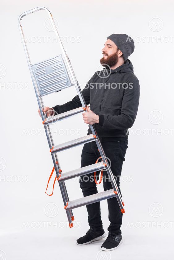 Full length photo of bearded man holding portable metal...