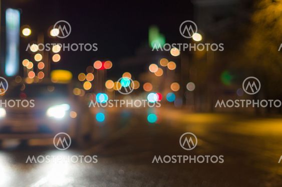 Car driving by blurred image, city road night lights on background
