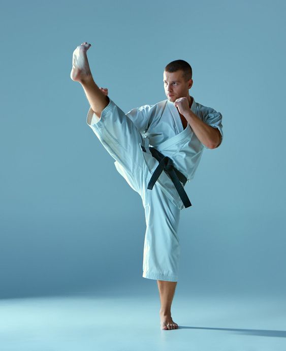Man in white kimono training karate