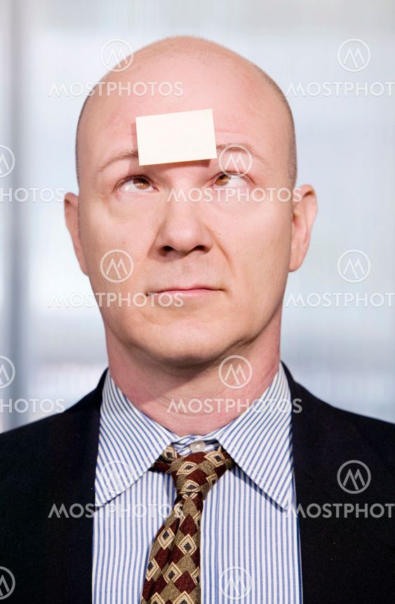 Businessman with a blank note on his forehead