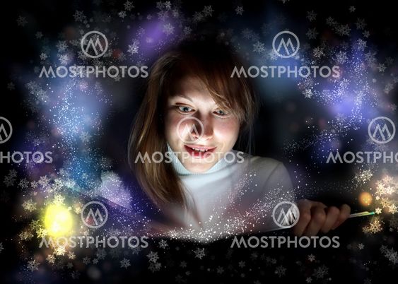 Young woman reading a magic book