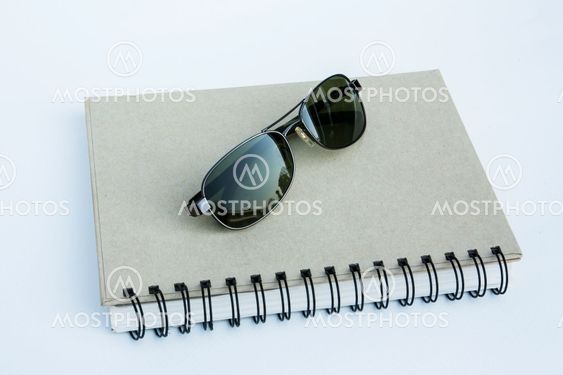Sunglasses on a spiral notebook