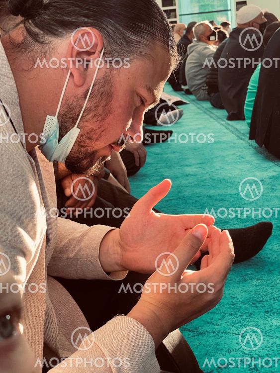 Dark tone, Muslim man praying with rosary beads in the...