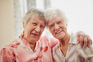 Friends, senior women and joy in retirement home with...
