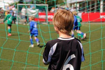 Young boy watching a football match