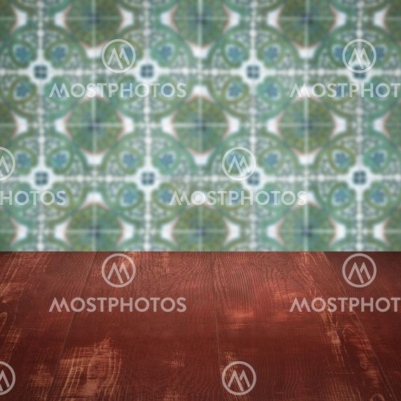 Wood table top and blur vintage ceramic tile pattern wall