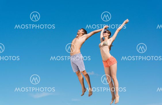 young couple jumping together