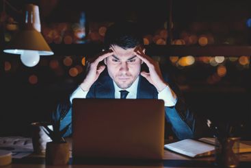 Concentrated Businessman At Laptop Thinking Working In...
