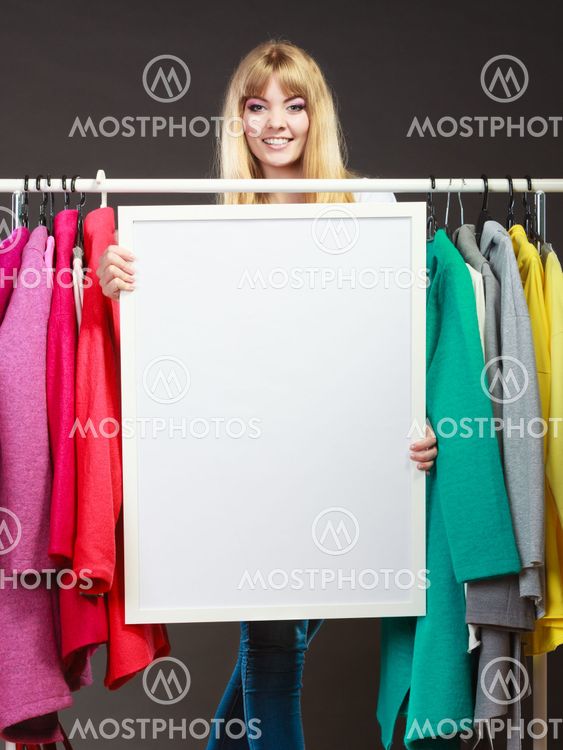 Woman in mall wardrobe with blank banner copyspace