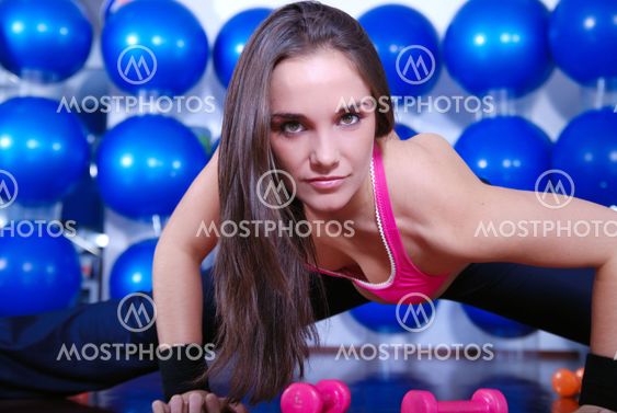 young pretty woman exercising in a fitness center