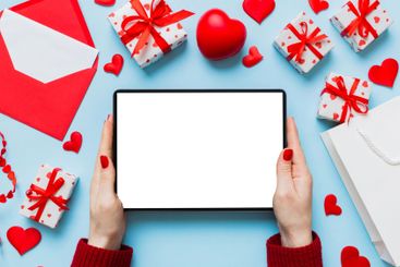 Female hands using a laptop for Valentine day...