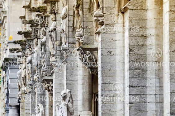 The facade of the Town Hall of the City of Brussels, a building of gothic architectural style from the middle ages decorated with numerous statues representing nobles, saints, and allegorical figures, located at the Grand Place in Brussels, Belgium