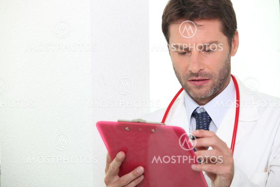 Doctor checking notes