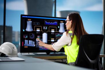 Young female professional monitoring SCADA system