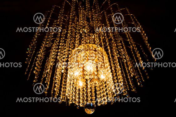 a crystal chandelier glows with golden light