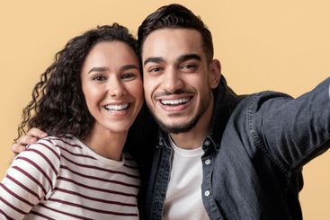 Romantic Cheerful Arab Couple Taking Selfie Together...