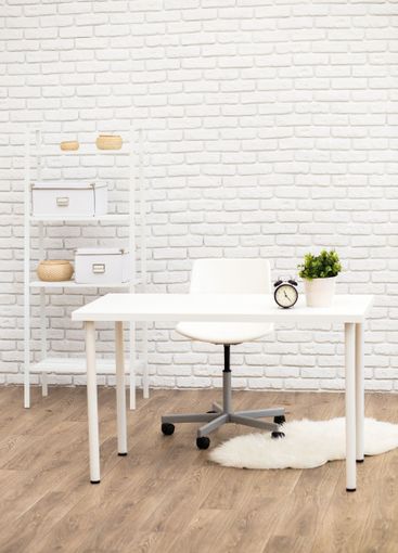 Simple and modern home office setup with white desk,...