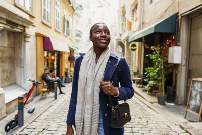 Young african woman walks alone on europe street