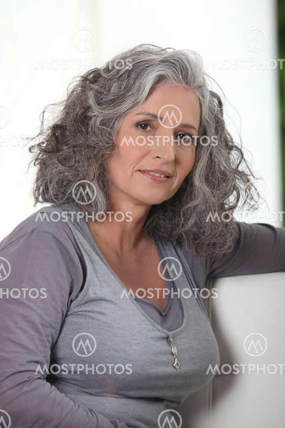 Grey-haired retired woman has a lot of free time