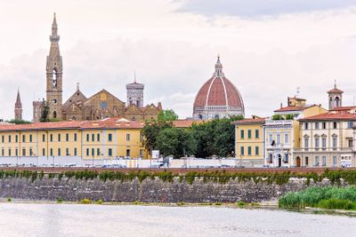 Daylight cloudy day close-up view to Arno river with...