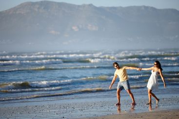 Beach, holiday and couple holding hands, walking and...