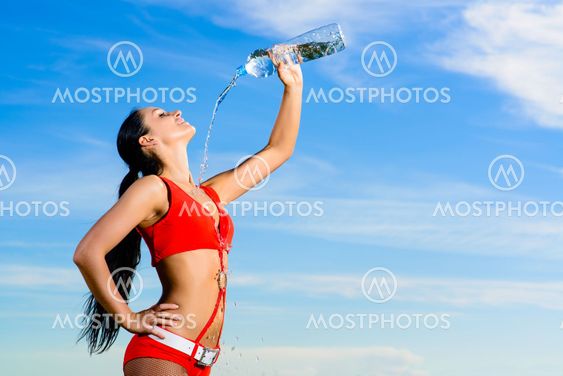 sport girl in red uniform with a bottle of water