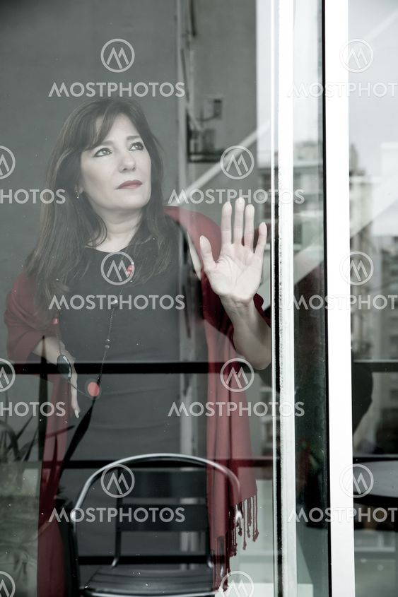 Mature woman looking out the window