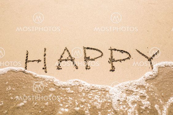 written words Happy on sand of beach