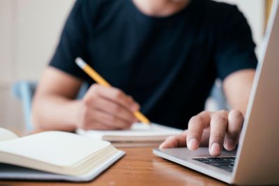 Closeup man hands using computer laptop.