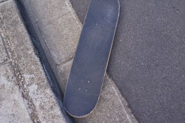 Skateboard, urban and asphalt with road above in city...