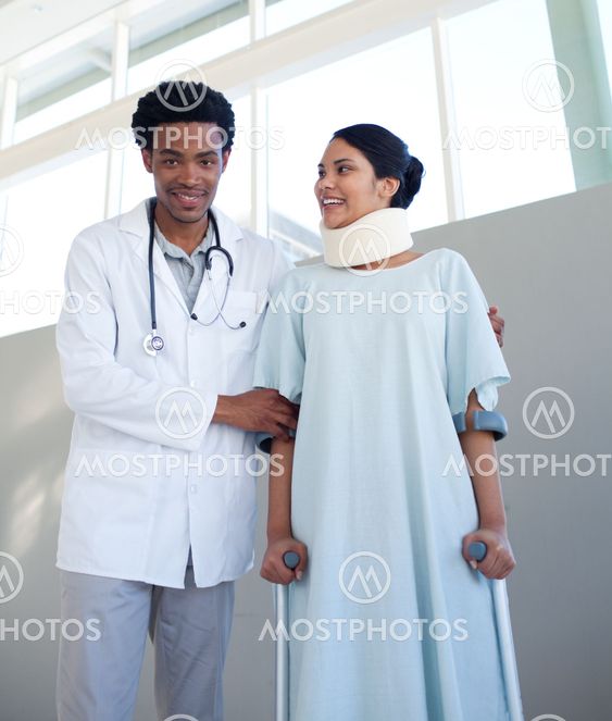 A doctor helping a patient with neck brace and on crutches